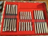 a red tray with a bunch of knives and knives in it