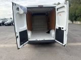 a white van with its doors open in a parking lot
