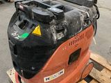 a close up of a forklift sitting on a pallet in a warehouse