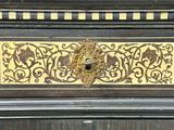 a close up of a clock with a decorative design on it