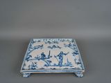 an old blue and white plate with birds and flowers on it