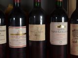 several bottles of wine are lined up on a table