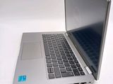 a silver laptop computer sitting on a white surface