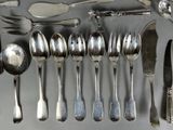 many spoons, forks, and spoon spoons laid out on a table