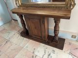 a wooden table with a mirror on top of it