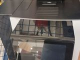 a microwave and toaster sitting on a shelf in a store