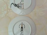 two plates that have a picture of a snake on them