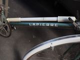 a close up of a bicycle parked on the side of the street