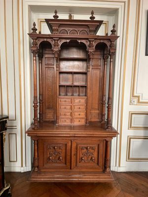 a large wooden cabinet in the middle of a room