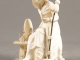 sculpture of a woman sitting on a chair with a cat