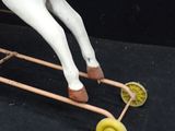 a toy horse that is sitting on top of a cart