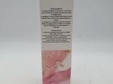 a close up of a bottle of liquid on a white surface