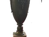 a large green vase sitting on top of a marble pedestal