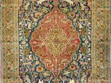 an antique persian rug with a floral design on a blue ground
