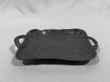 a black metal tray with handles and handles on a white background