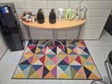 a small table with a coffee pot on it in a kitchen