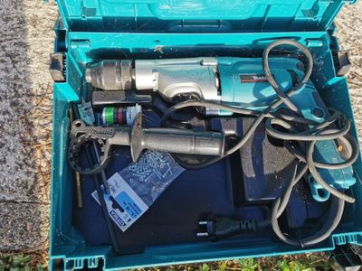 a blue box with tools in it sitting on the ground
