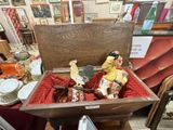 a wooden box with a statue of a clown inside of it