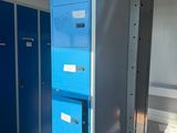 several blue lockers are lined up in a row in a room
