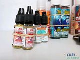 many bottles of liquid sitting on a table next to each other