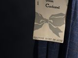 a label on a blue dress hanging from a hanger