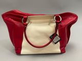 a red and white handbag with a tag on it