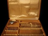 a wooden case with silverware in it on a black background