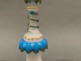 a blue and white vase with a gold decoration on it