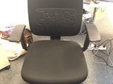 a black office chair sitting in front of a computer monitor