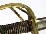 a close up of a sword with a gold handle