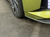 a close up of a green car with its door open