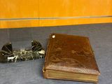 a brown book sitting on a table next to a pair of scissors
