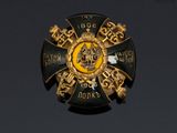 an image of a gold and black badge with a lion on it