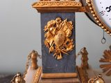 a clock that is sitting on a table next to a clock