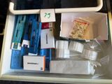 a drawer full of items that are sitting on a table