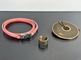 two belts and a ring on a table