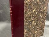 a book with a red cover sitting on top of a table