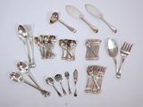 a lot of silver spoons and forks on the table