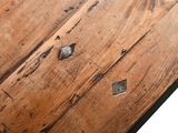 a close up of a wooden table with holes in it