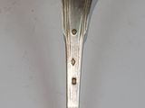 a spoon with a sticker on it sitting on a table