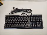 a black keyboard and a mouse on a white table