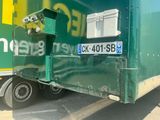 a green truck that is parked in a parking lot