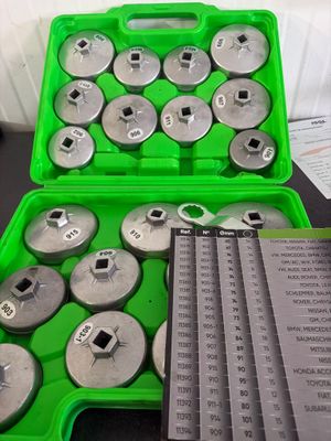 a lot of tools in a green case on a table