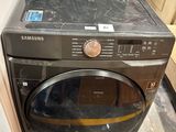 a black washer and dryer sitting in a room