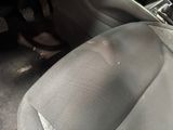 a close up of a seat in a car with a dirty seat belt