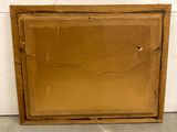 an old picture frame with a hole in it sitting on the floor