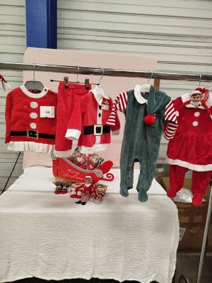 a display of baby clothes for sale at a christmas market