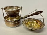 a silver bowl and a silver bowl with a spoon in it