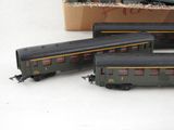 three toy trains sitting next to each other on a table