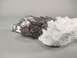 a piece of rock with a white substance on top of it